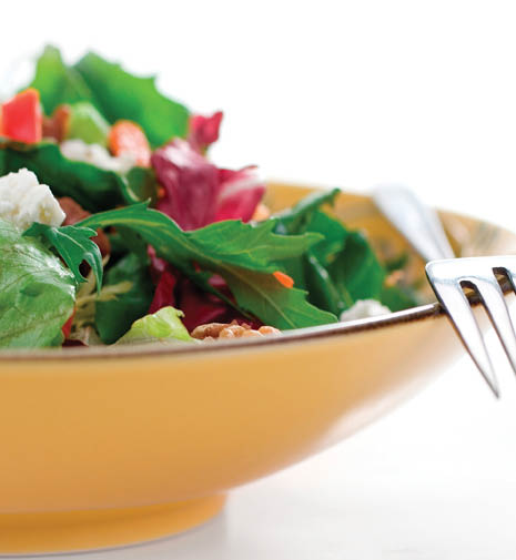 A super delicious salad of mixed organic wild greens, goat cheese, walnuts, peppers and a sweet vinigrette   Shallow dof 